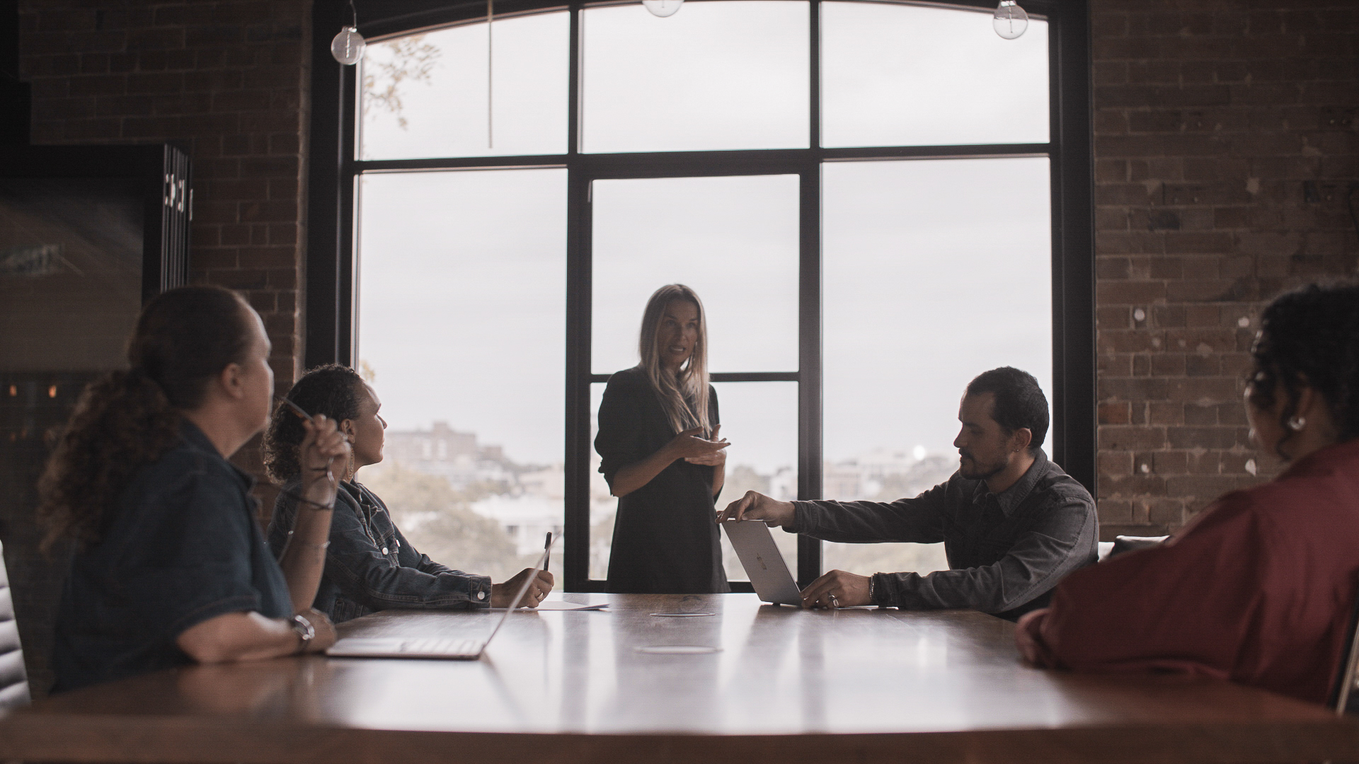 A leader presenting to a team around a boardroom table